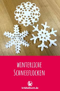 paper snowflakes on a wooden table with the words winterlie schneflocken