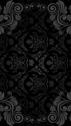 an ornate black and white background with swirls, leaves and flowers in the center