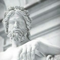 black and white photograph of a statue of jesus holding the hand of another man's arm