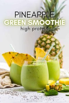 pineapple green smoothie in two glasses with straws on the rim, and garnishes