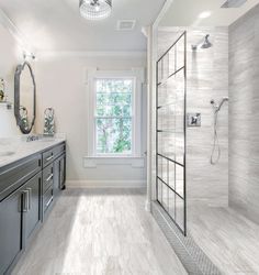 a large bathroom with white walls and wood flooring on the shower, sink, and bathtub