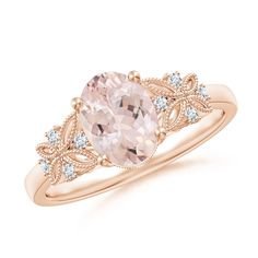 This exquisite vintage-style ring in 14k rose gold showcases a delightful oval morganite in a prong setting. It is intricately designed with butterfly motifs on the band, leaf-shaped cutwork in the gallery and fine beading details. The diamond accents on the top and the front of the shank add a brilliant touch to this ring. Oval Morganite Ring, Morganite Jewelry, Pretty Engagement Rings, Vintage Style Rings, Morganite Ring, Pear Shaped Diamond, Morganite, The Gallery, Prong Setting