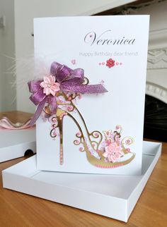 a birthday card with a high heel shoe decorated with pink and purple flowers on it