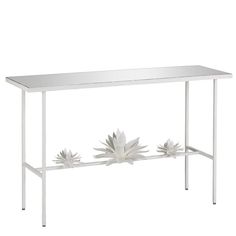 a white console table with flowers on it