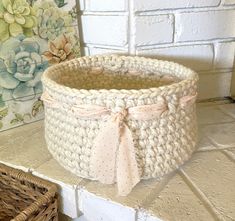 a white basket sitting on top of a counter