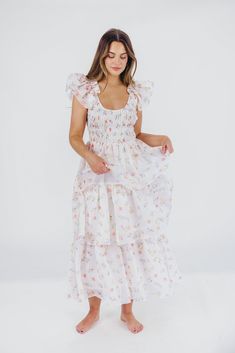 Meet the "It" dress of the season: this midi is our new favorite, forever and always! Crafted from a premium fabric in the most exquisite floral pattern, it features a feminine, flouncy silhouette and ruffle details that will capture your heart - and the spotlight. Whatever special event is next on your calendar - spring weddings, maternity photos, christenings or baby showers - the Forever & Always will set you apart from the crowd in the most elegant of ways. FIT: Runs true to size. Dress will accommodate most baby bumps; note that the bodice is smocked, which could prove restrictive if you are in advanced maternity and carrying high. MATERIAL: Self: 100% Polyester; Lining: 100% Cotton. Hand wash cold; do not bleach, do not tumble dry. Line dry, low iron if needed. GARMENT DETAILS: Light Feminine Midi Dress With Smocked Bodice In Maxi Length, Elegant Floral Dress With Smocked Bodice For Garden Party, Wedding Midi Dress With Smocked Bodice, Forever And Always, Curve Model, Long Midi, Organza Dress, Cute Prom Dresses, Church Dresses