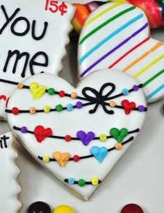 two decorated heart shaped cookies sitting next to each other