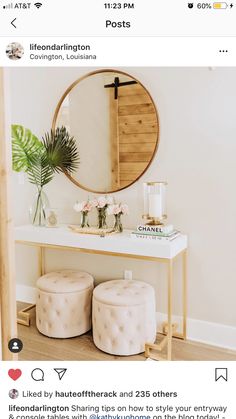 a table with two stools and a round mirror