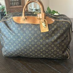 Louis Vuitton Alize Two Pocket Travel Bag Keep All Bandolier 50 Brown Monogram With Complete Lv Luggage Tag . It’s Already Been To Poshmark Once! Bag Is In Excellent Pre Loved Condition! This Travel Bad Is Perfect For Both Men And Women! With(Inches). 21.6 Inches (Approx) With (Cm). ,5cm (Approx) Height (Cm). 42 Cm (Approx) Height (Inches). 16.5 Inches (Approx) Depth(Inches). 5.1 Inches (Approx) Depth (Cm). 13.Cm (Approx) Designer Brown Travel Bag For Trips, Luxury Pre-owned Travel Shoulder Bag, Designer Brown Bag For Trips, Luxury Coated Canvas Bags For Trips, Rectangular Monogram Canvas Bag With Luggage Sleeve, Designer Monogram Canvas Travel Bag With Luggage Sleeve, Designer Brown Travel Bag For Business Trips, Luxury Pre-owned Brown Bag, Brown Monogram Canvas Bags For Business Trips