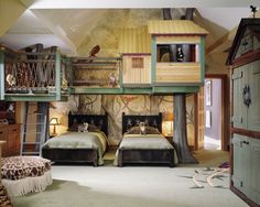 two beds in a room with bunk beds on top of each other and a ladder to the second floor