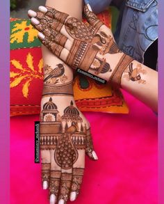 two hands with henna designs on them