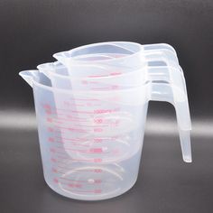 three measuring cups are stacked on top of each other in front of a gray background