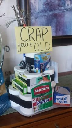 a cake made to look like it is stacked on top of each other with a sign that says crap you're old