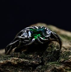 a green ring sitting on top of a rock