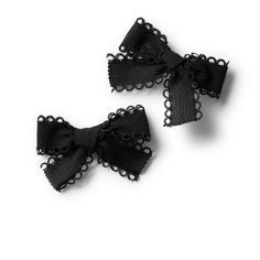 two small black bows with lace on them are sitting side by side in front of a white background