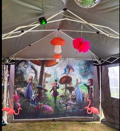 an outdoor tent with decorations and lights on it