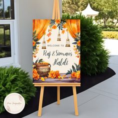 an easel with a welcome sign and potted plants in front of a house