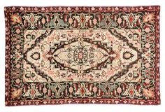 an antique persian rug with red, green and beige colors on the bottom half of it