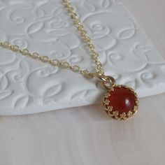 "* Beautiful Carnelian (8mm) pendant set in a gold plated bezel and complimented with a gold-filled chain in 16\", 18\", or 20\" lengths. Each necklace may vary and have it's own individual coloring and no two will look alike. * The Carnelian properties are said to promote positive life choices, give courage, motivate for success, leadership, and dispels apathy. * This Carnelian pendant has an open back. * This Carnelian necklace is a limited item. * Love Carnelian ~ * Single Point Carnelian Nec Carnelian Choker, Carnelian Properties, Bead Diy, Carnelian Jewelry, Carnelian Crystal, Carnelian Necklace, Carnelian Pendant, Bracelet Minimalist, Carnelian Ring