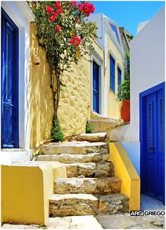 the steps lead up to some buildings with blue doors