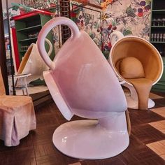 two chairs and a vase on display in a store