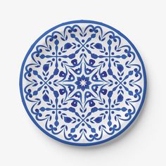 a blue and white plate with an intricate design on the front, against a white background