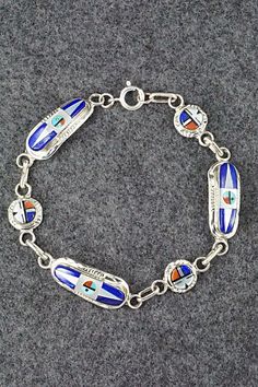 "This lapis, coral, turquoise, mother of pearl, onyx and sterling silver sun face link bracelet was made by Zuni silversmith Patty Edaakie. The back is signed. Size: 8 1/2\" Width: 1/2\" Free shipping on all orders! We ship with USPS and always include tracking. All orders ship within a day of payment. Returns are accepted up to 30 days after you receive your order. Just send us a message. Our shop offers cash back or store credit. The item must be returned in new condition." Sun Face, Silver Link Bracelet, Coral Turquoise, Multi Stone, Native American Jewelry, Bracelets And Charms, Free Jewelry, Link Bracelets, Mother Of Pearl