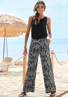 Embrace the artistry of fashion with our eye-catching wide-leg printed pants. Chic Patterned Bottoms For Vacation, Chic Patterned Bottoms For Summer, Chic Patterned Summer Bottoms, Summer Wide Leg Patterned Pants, Chic Patterned Bottoms With Floral Print, Summer Patterned Printed Wide Leg Pants, Chic Floral Print Patterned Bottoms, Summer Wide Leg Patterned Bottoms, Summer Patterned Wide Leg Bottoms