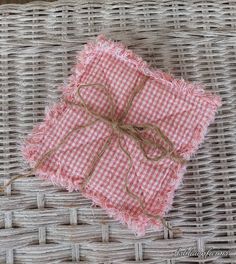 two pieces of cloth tied together on top of wicker basket with twine and burlap