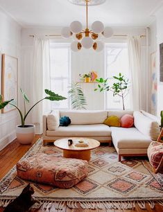 a living room filled with furniture and plants