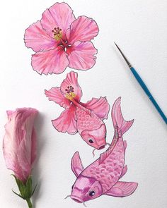 a pink flower and two fish on a white paper with watercolor pencils next to it