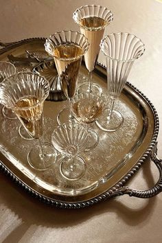 a silver tray with wine glasses on it