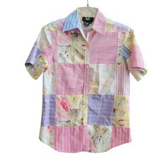 This vintage Lauren Ralph Lauren shirt is a unique addition to any wardrobe. The shirt features a patchwork design in a mix of floral and stripe patterns, with short sleeves and a button closure. It is made from 100% cotton and has a regular fit, with a size type of petites. The shirt is perfect for summer, fall, or spring seasons and is a great basic item for any woman's closet. Measurements Pit to Pit 18" Shoulder to Hem 25" Spring Patchwork Button-up Shirt, Striped Cotton Tops With Patchwork, Spring Short Sleeve Patchwork Shirt, Multicolor Patchwork Shirt For Spring, Spring Multicolor Patchwork Shirt, Spring Short Sleeve Tops With Mixed Print, Spring Mixed Print Short Sleeve Tops, Retro Patchwork Shirt For Spring, Fitted Patchwork Button-up Shirt