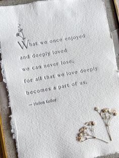 a piece of paper with a poem written on it next to some flowers and leaves