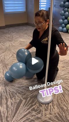 a woman kneeling on the floor with balloons