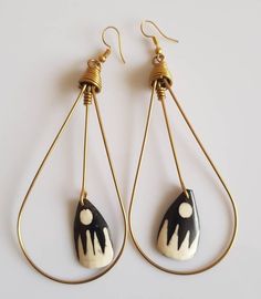 Hand made earrings.  They are made of Brass and cowrie shell. The earrings are all made to order The list is for 5 pairs of earrings. They are all 100% hand made. All items are shipped through dhl express. Handmade White Beaded Brass Earrings, Handmade Teardrop Hoop Earrings For Beach, Handmade Brass Dangle Teardrop Earrings, Handmade Adjustable Brass Teardrop Earrings, Handmade Brass Teardrop Dangle Earrings, Handmade Metal Teardrop Earrings, Handmade White Brass Hoop Earrings, Unique Handmade Gold Teardrop Earrings, Handmade Metal Teardrop Plug Earrings