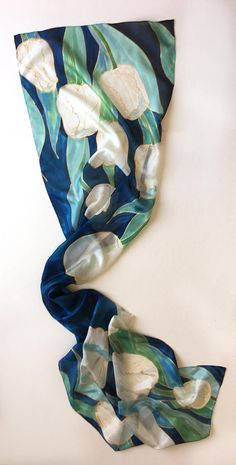 "Welcome to klaradar! https://www.etsy.com/uk/shop/klaradar?ref=seller-platform-mcnav Navy Tulips Silk Scarf/ Hand Painted Scarf/ Dark Blue Floral scarf painted. White Tulips painted on Deep Blue background. Unique handmade gift for women, Christmas gift mom. Silk Painting by Klaradar/ Christmas gift for mother-in-law. ►measurements- 17\"x71\" This Blue Tulips Scarf is painted on pure silk pongee 5. ►SHIP NEXT DAY See my luxury scarves and shawls here: https://www.etsy.com/shop/klaradar?ref=l2-s Artsy Blue Scarf Perfect As A Gift, Artsy Blue Scarf As A Gift, Artsy Blue Scarf For Gift, Artsy Blue Scarf As Gift, Artsy Blue Scarves As Gifts, Handmade Blue Scarf As A Gift, Handmade Blue Scarves As Gifts, Hand Painted Blue Silk Scarf For Gift, Artsy Blue Silk Scarf As Gift