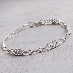 Petite heart shapes are featured in each link along the length of this Peruvian bracelet. Designed by Alfredo Inga, the link bracelet is handcrafted from sterling silver, with elegant, spiraling filigree motifs. Vintage Wedding Jewelry, Sweet Hearts, Filigree Heart, Filigree Bracelet, Heart Motif, Filigree Jewelry, Handmade Wire Jewelry, Sterling Silver Filigree, Bridal Bracelet