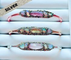 This silver-plated cuff bracelet is a beautiful combination of Australian opals with your choice of a centered purple angel aura quartz, green angel aura quartz, or pink angel aura quartz. Not only is Opal a birthstone for October but Opal is a stone of Inspiration and Imagination. Upon checkout please select purple, green, or pink for the centered angel aura quartz and size. This exquisite piece is also available on a gold or rose gold bracelet. Please inquire. Great for stacking and adjustable Purple Angel, Silver Boho Jewelry, Green Angel, Gold Arm Band, Customised Bracelets, Pink Angel, Raw Crystal Jewelry, Angel Aura Quartz, Gold Armband