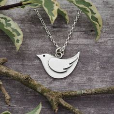 This little bird pendant and it's wing decoration are hand pierced (sawn out) from sterling silver sheet using a fine jewellers saw.   All components are then silver soldered together.   It has been oxidised to enhance features of it's design and has been given a gorgeous matt satin finish.  The bird measures approximately 23.5mm wide by 16mm high (including the jump ring) and is suspended from a lovely sterling silver mini oval belcher chain.  If you would prefer different length necklace or indeed different size bird pendant, please do get in touch to discuss your requirements. Many thanks for visiting.   Please do get in touch if you have any more questions. Fee * A note about hallmarking: By UK law, all sterling silver items for sale weighing 7.78g or over must be hallmarked by one of Wing Decoration, Bird Jewellery, Silver Bird Necklace, Hand Piercing, Pebble Pendant, Silver Clay, Silver Bird, Belcher Chain, Metal Clay Jewelry