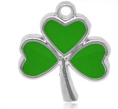 a green shamrock shaped charm with four leaf clovers on the front and back of it