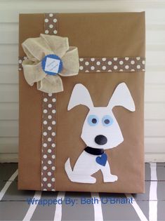 a brown paper bag with a dog on it and a blue bow around the neck