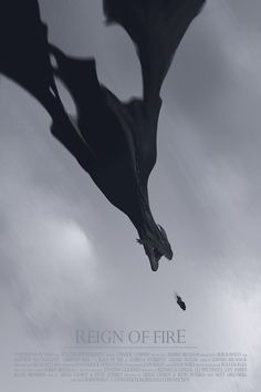 a black and white photo of a dragon flying in the sky