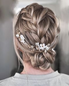 a woman with braids and flowers in her hair