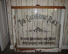 an old window and sign that says the gathering place where memories are made with family and friends