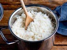 rice in a pot with a wooden spoon