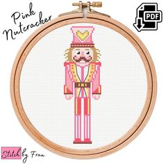 a cross stitch pattern with a pink nutcracker