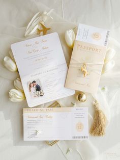 the wedding stationery is laid out on top of the bed with tulips