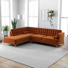 an orange sectional sofa sitting on top of a white rug