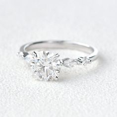 a diamond engagement ring on a white background